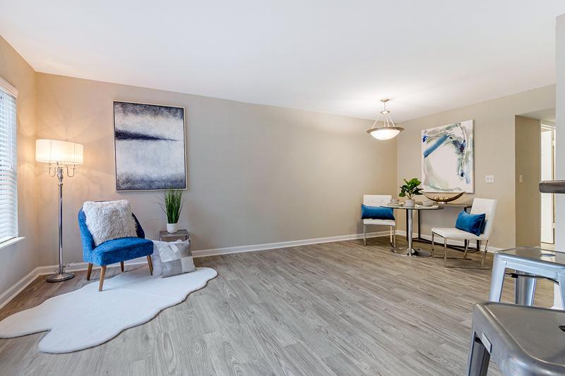 Living Room | Relax in your spacious living room featuring wood-style flooring and large windows.