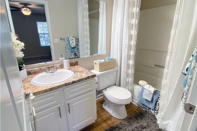 Spacious Upgraded Bathrooms | Newly remodeled bathrooms featuring granite-style counter tops and large mirrors.