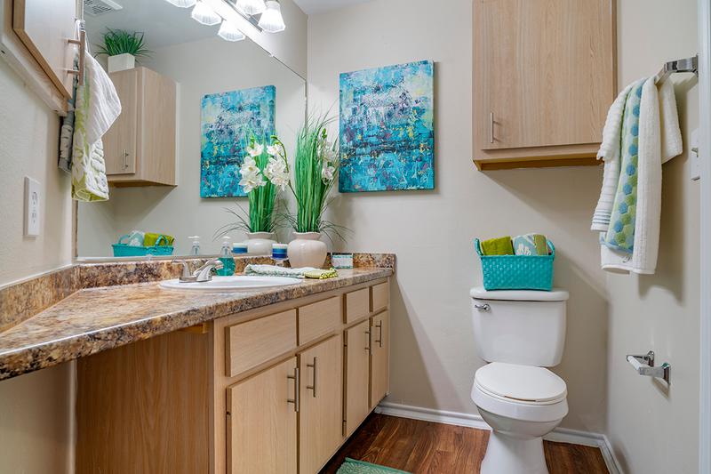 Bathroom | Newly remodeled bathrooms featuring granite-style counter tops, large mirrors, and garden tub.