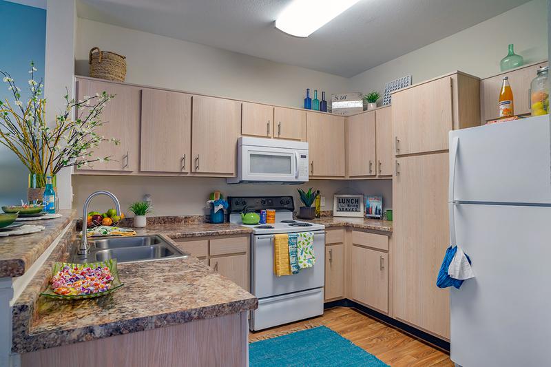 Kitchen | Newly remodeled kitchen with granite-style counter tops and all electric appliances. Includes a breakfast bar that opens up to the living room.