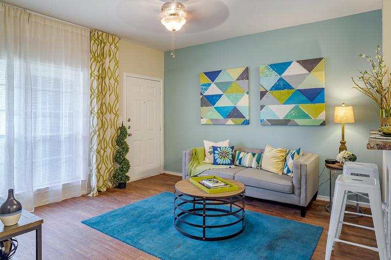 Living Room | Spacious living rooms featuring wood-style flooring.