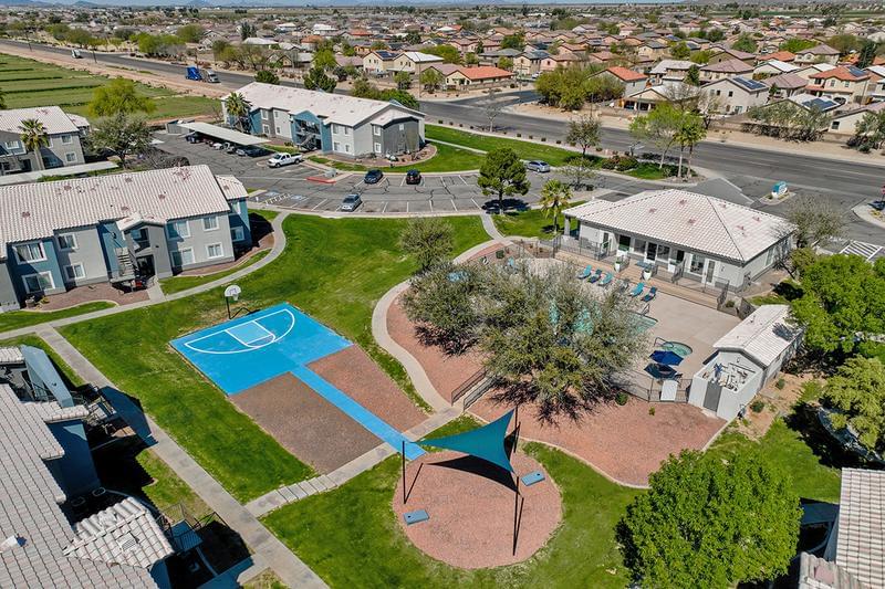 Outdoor Amenities | An aerial view of our outdoor amenities including a basketball court, cornhole area, and pool.