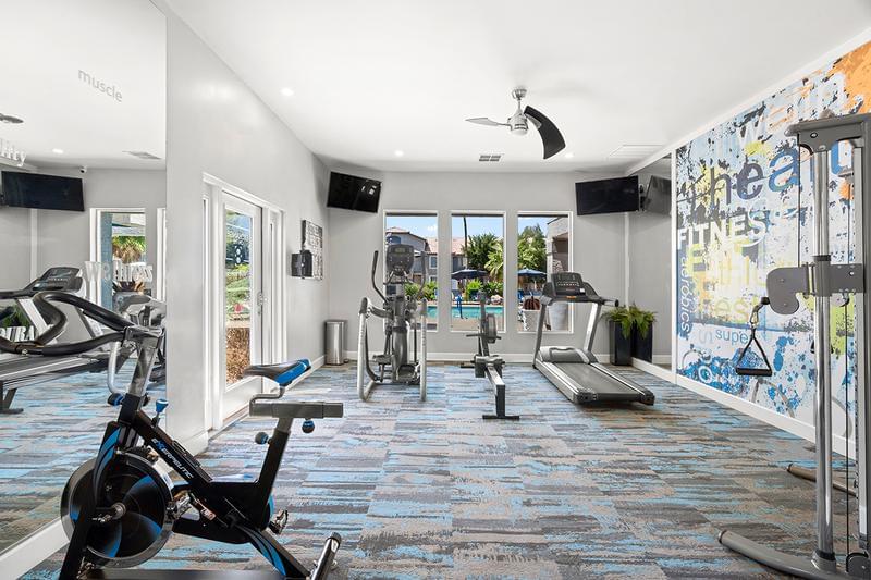 Fitness Center | Our newly renovated fitness center features gorgeous views of the pool, state-of-the-art equipment, televisions, and free weights!