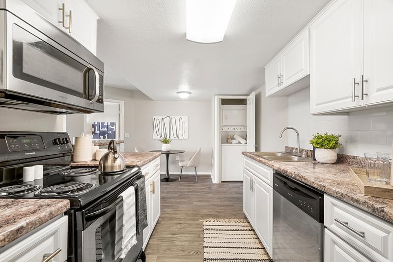 Galley Style Kitchens | Newly renovated, galley style kitchens featuring stainless steel appliances.
