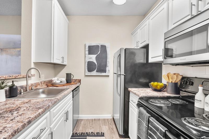 Renovated Kitchen with Tile Backsplash | Your newly renovated kitchen is complete with a tile backsplash and breakfast bar.