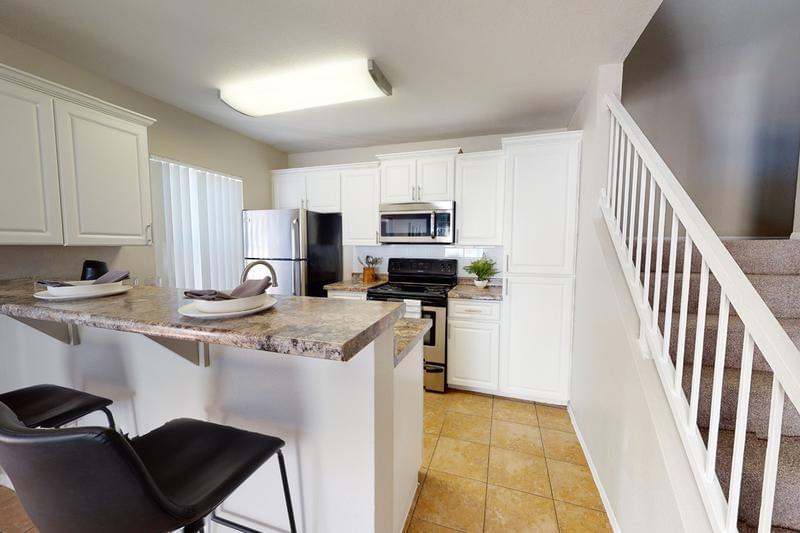 Townhomes with Remodeled Kitchens | Our remodeled kitchens feature subway tile backsplashes, granite-style counter tops and stainless steel appliances. 
