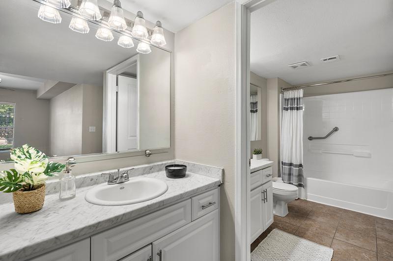 Spacious Remodeled Bathroom | Our newly remodeled bathrooms feature wood-style or tile flooring, marble-style countertops, and large mirrors.