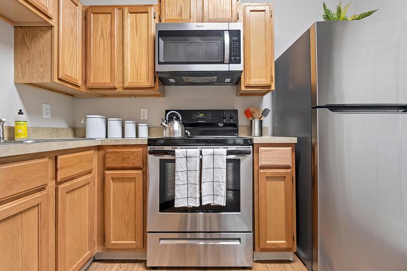 Fully Applianced Kitchen | All kitchens are complete with a refrigerator, stove, dishwasher and brand-new stainless-steel microwave.