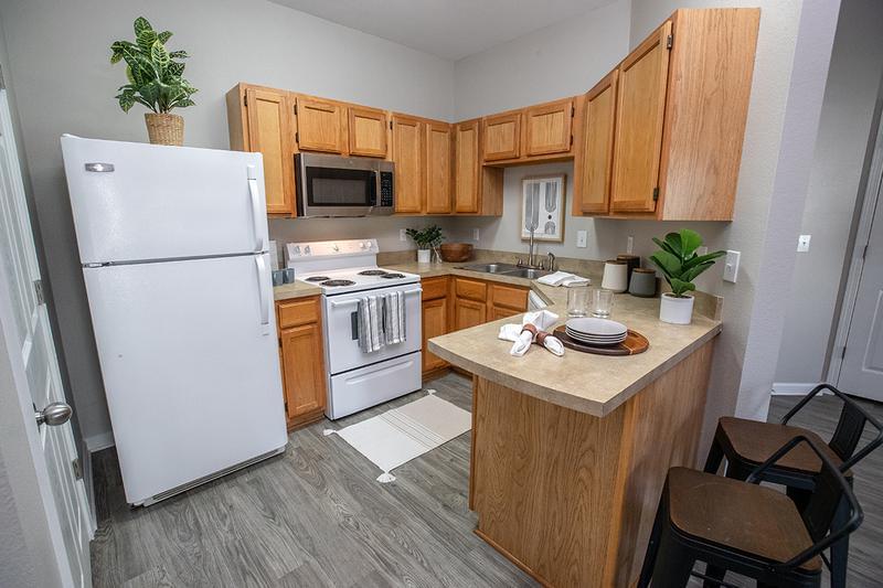 Kitchen with Breakfast Bar | Our fully equipped kitchens feature a breakfast bar overlooking a spacious living area.