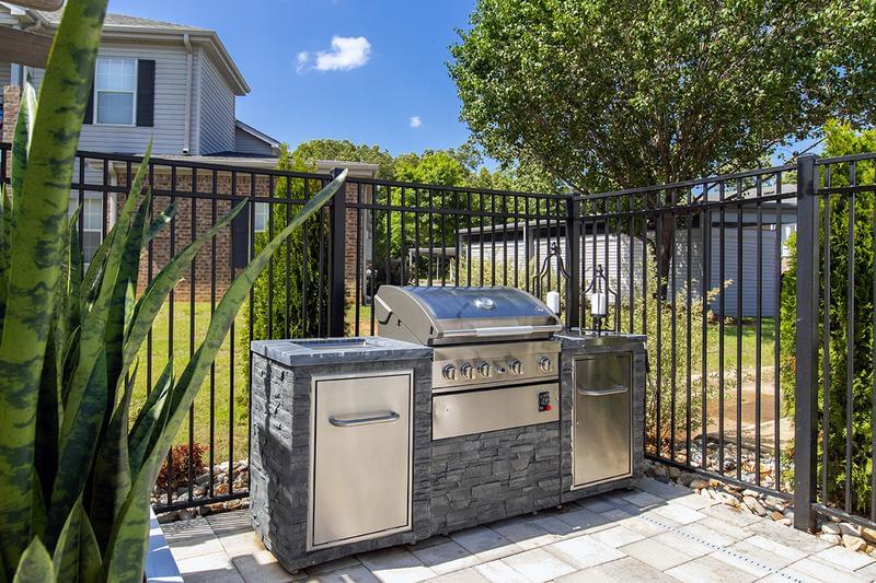 Outdoor Kitchen | Have a cookout by the pool at our outdoor kitchen featuring a gas grill.