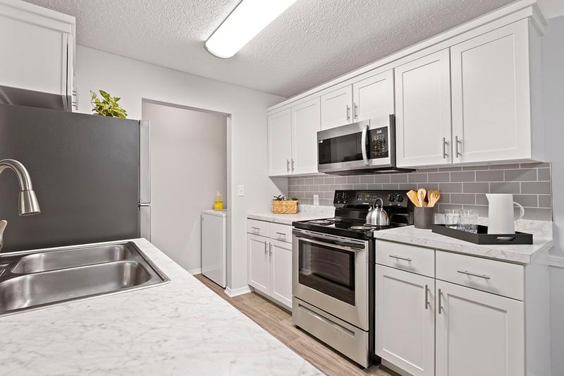 Renovated Kitchens | All of our kitchens have been newly renovated with an abundance of cabinet space, stainless steel appliances and a lowered bar top overlooking your living room.