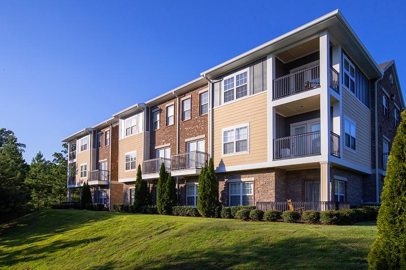 Building Exterior | Updated exterior featuring lush landscaping and private patios and balconies our residents enjoy.