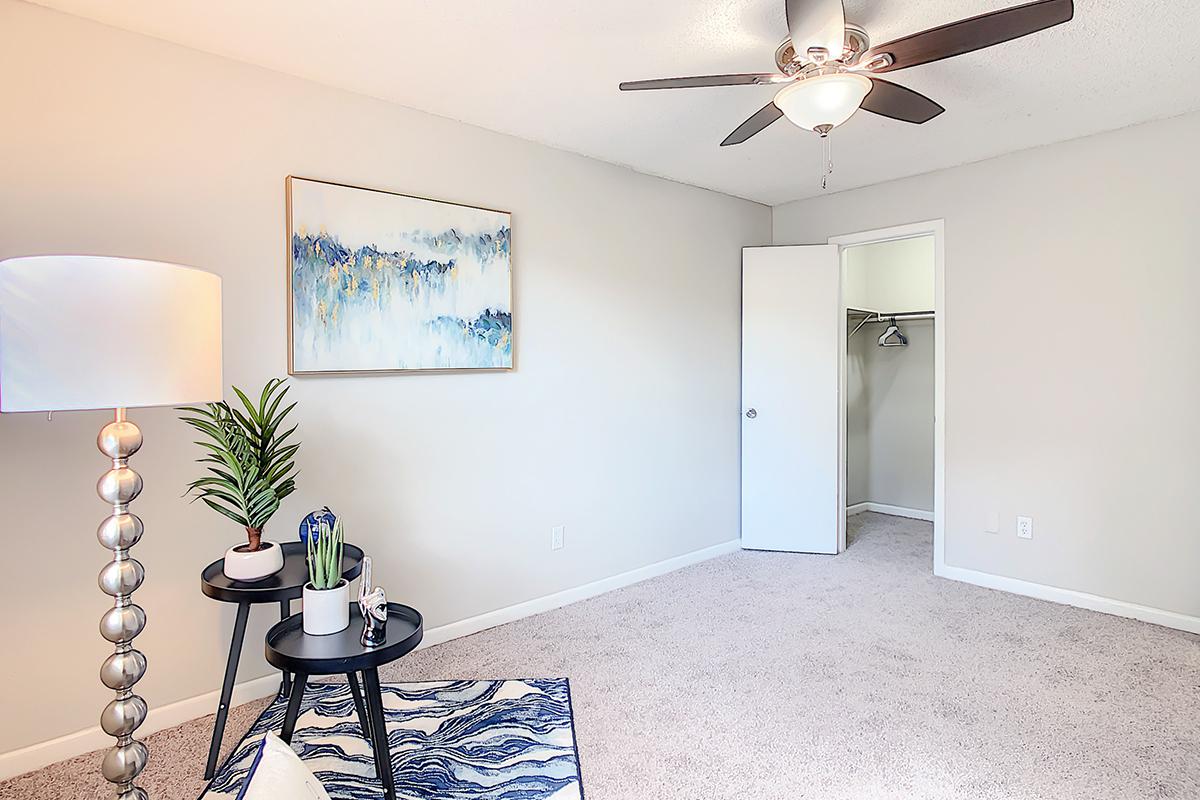 Spacious bedrooms featuring a multi-speed ceiling fan and walk-in closet.
