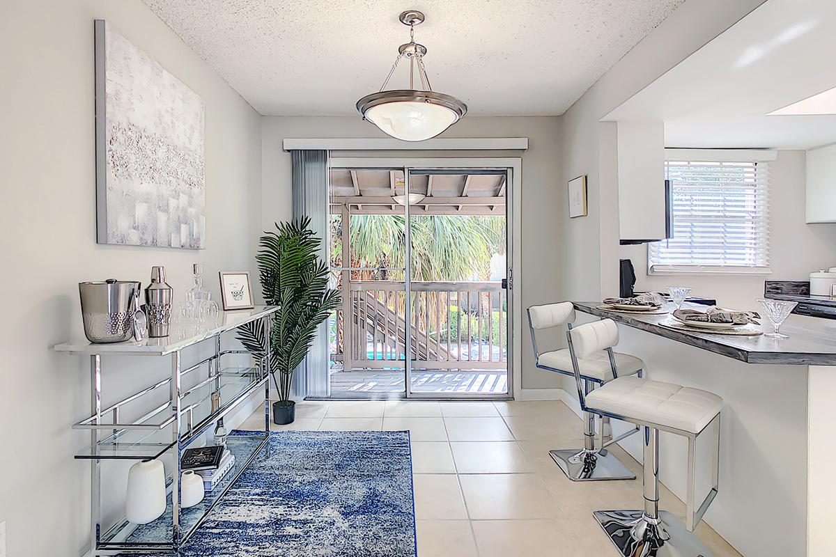 Separate dining area featuring tile flooring and contemporary lighting.