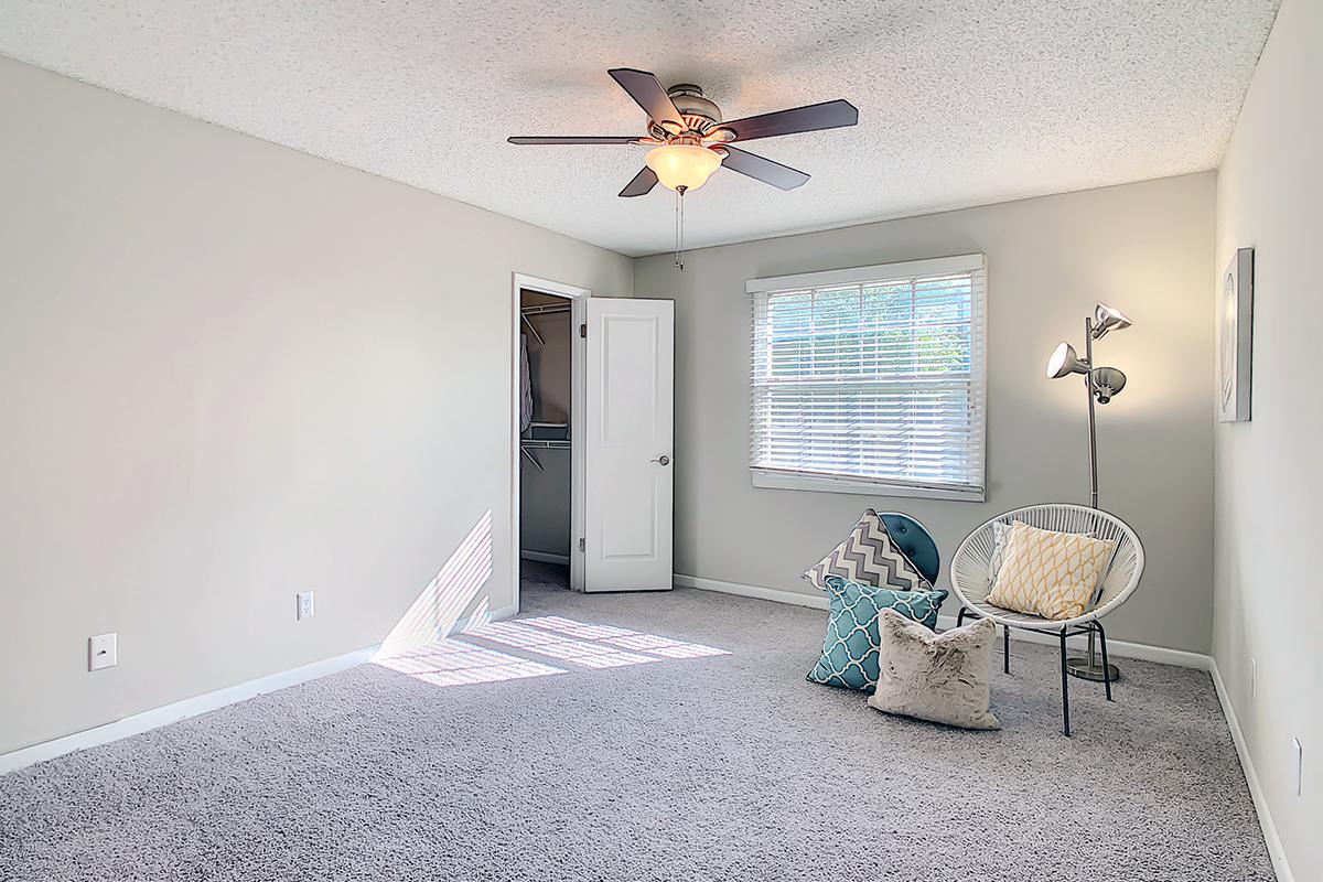 Spacious guest bedrooms featuring plush carpeting, spacious closet, and a large window.