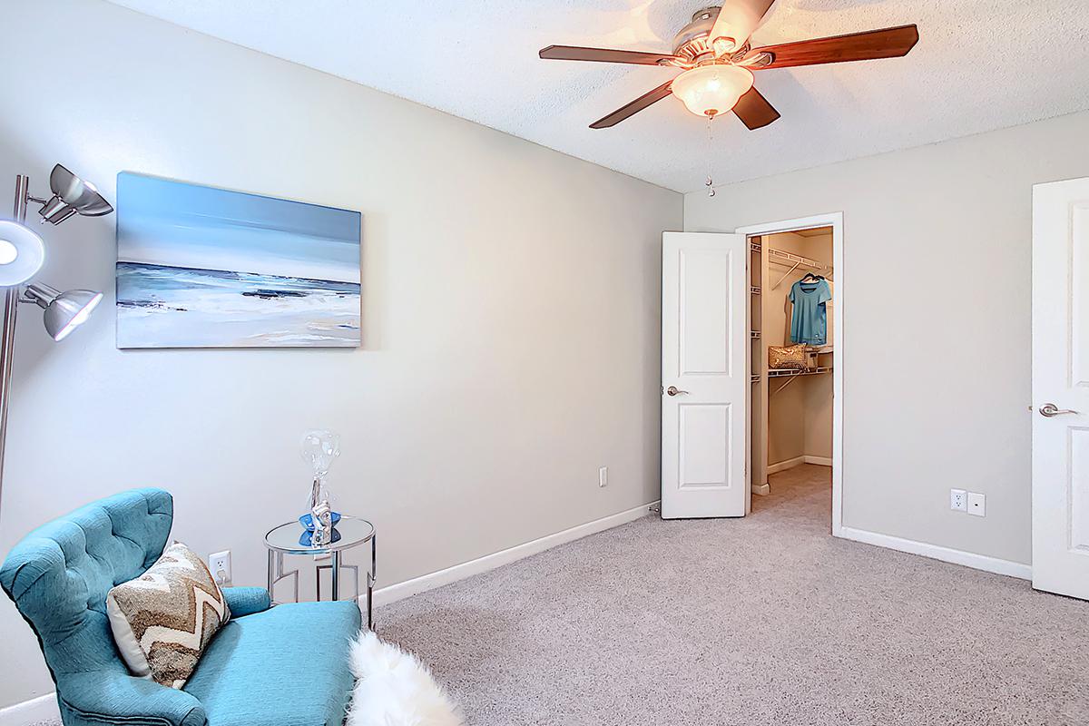 Bedrooms featuring plush carpeting and a ceiling fan.