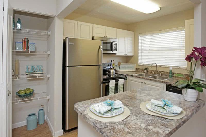 Newly Remodeled Kitchens | Our apartment homes feature newly remodeled kitchens featuring granite-style countertops, stainless steel appliances, and a pantry.