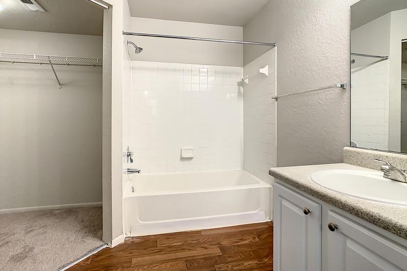 Bathroom & Large Closet | Spacious bathrooms featuring wood-style flooring.