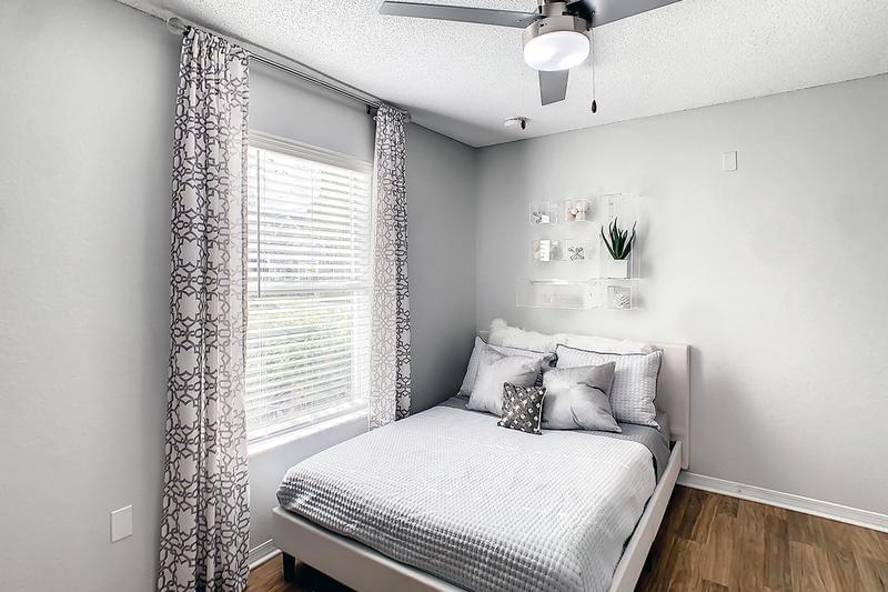 Guest Bedroom | Bedrooms feature ceiling fans and wood-style flooring.