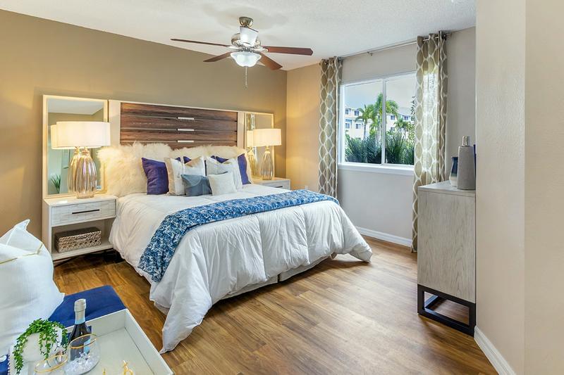 Master Bedroom | Spacious master bedrooms featuring wood-style flooring and a multi-speed ceiling fan.