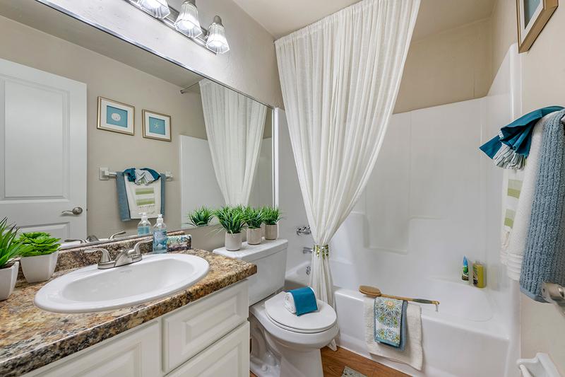 Bathroom | Every bathroom is newly remodeled featuring updated countertops, cabinetry, and wood-style flooring.