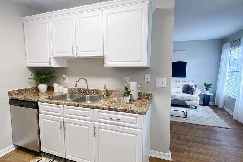 Updated Kitchens | Updated kitchens also feature white cabinetry and wood-style flooring.