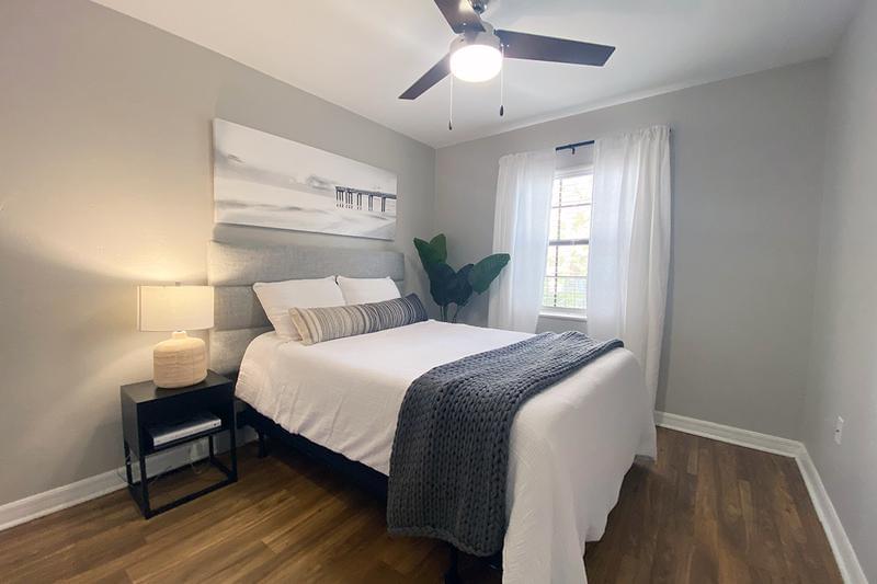 Bedroom | The spacious bedrooms with walk-in closets also feature beautiful views of our lush landscaping and sparkling pond.