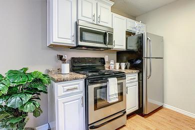 Updated Kitchens | Your newly renovated kitchen in the Deluxe Chateau floor plan features upgraded white cabinetry and modern stainless steel appliances.