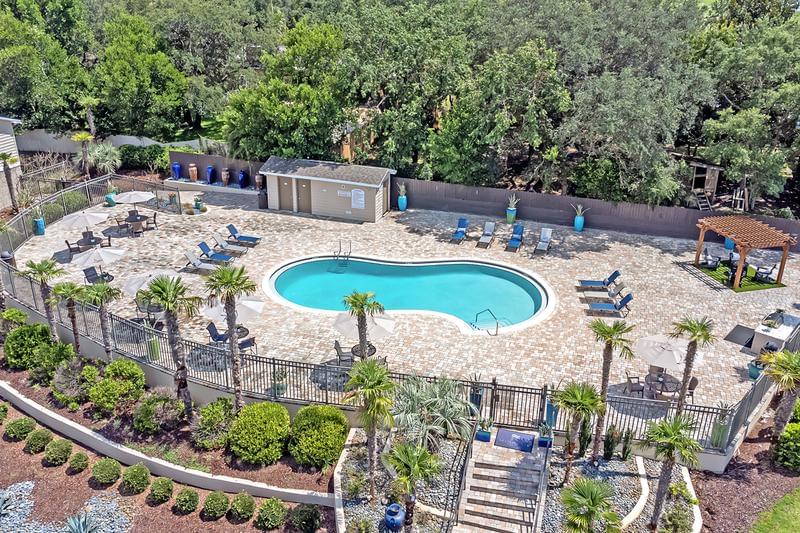 Aerial View of Pool | A bird's eye view of our expansive sundeck and resort-style pool surrounded by lush landscaping.