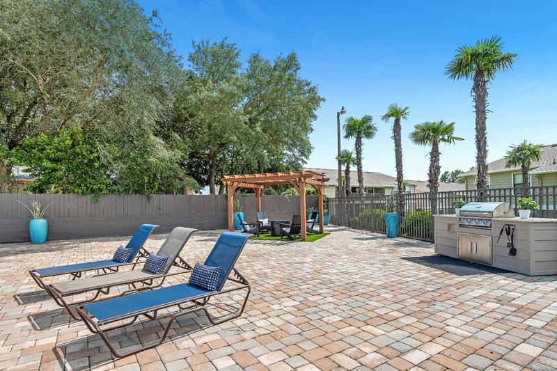 Outdoor Kitchen | Have a cookout by the pool at our outdoor kitchen featuring a gas grill.