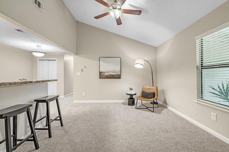 Living Room | Spacious, open living rooms featuring plush carpeting, vaulted ceilings and a multi-speed ceiling fan. 