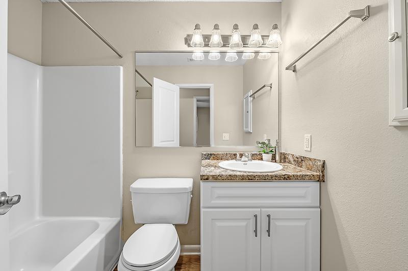Bathroom | Bathrooms feature large mirrors, granite-style countertops and a medicine cabinet.