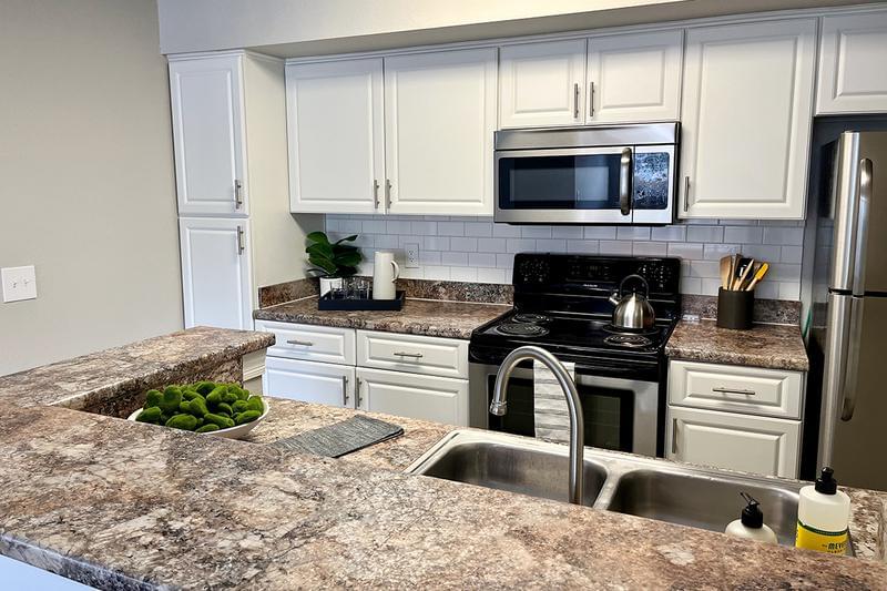 Updated Kitchens | Our updated kitchens feature wood-style flooring, granite-style counter tops and stainless steel appliances. 