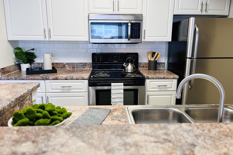 Stainless Steel Appliances | Kitchens featuring stainless steel appliances and a breakfast bar.