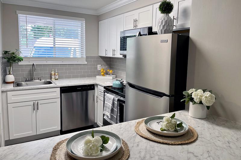 Kitchen with Backsplash | Updated kitchens featuring granite-style countertops, stainless steel appliances, and a backsplash are also available.