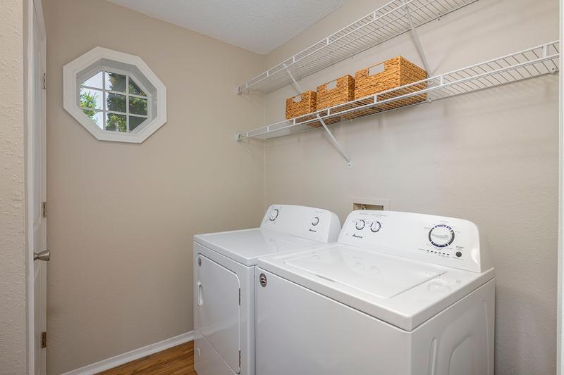 Laundry Room | Extra storage space and full-size washer and dryer appliances.