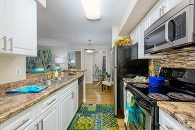 Galley Style Kitchens | Galley style kitchens featuring wood-style flooring and stainless steel appliances.