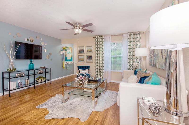Living Room | All Living rooms feature wood-style flooring and multi-speed ceiling fans.