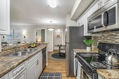 Galley Style Kitchens | Galley style kitchens featuring wood-style flooring and stainless steel appliances.