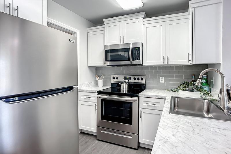 Renovated Kitchens | Premium kitchens with shaker cabinetry, plank flooring and new appliances.