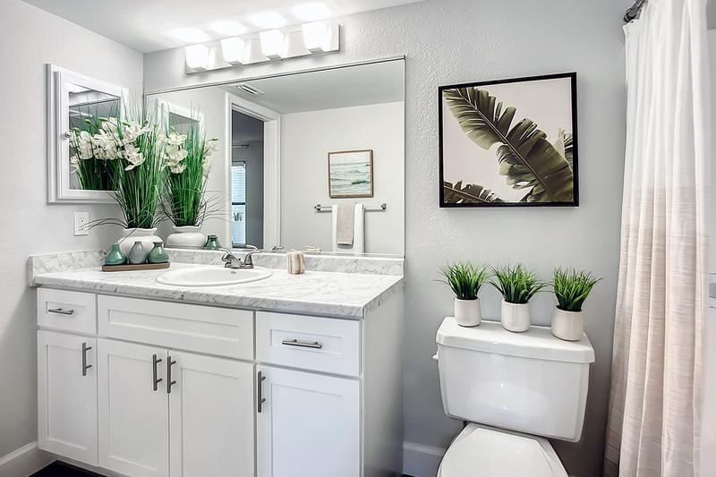 Renovated Bathrooms | Bathrooms feature new cabinetry, flooring and modern counters.