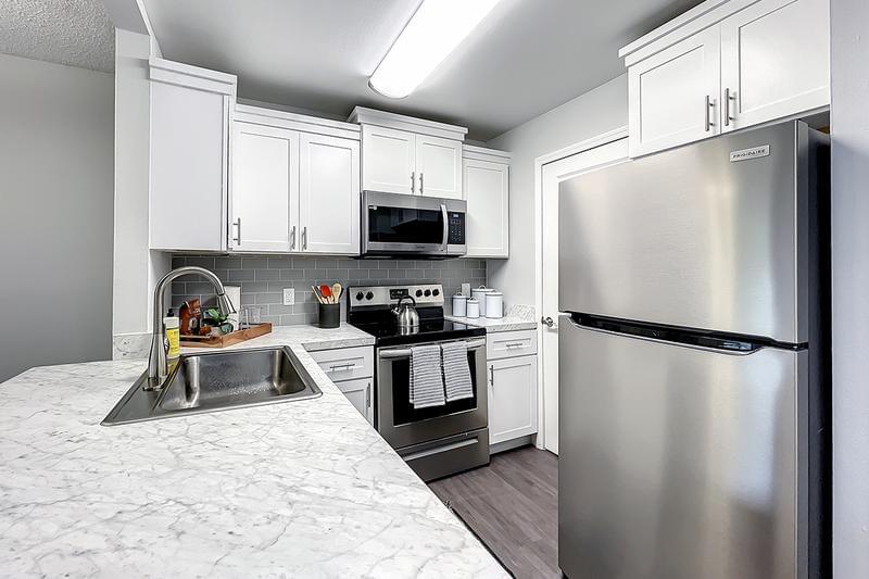 Stainless Steel Appliances | Newly renovated Kitchens feature stainless steel appliances with glass top stoves.