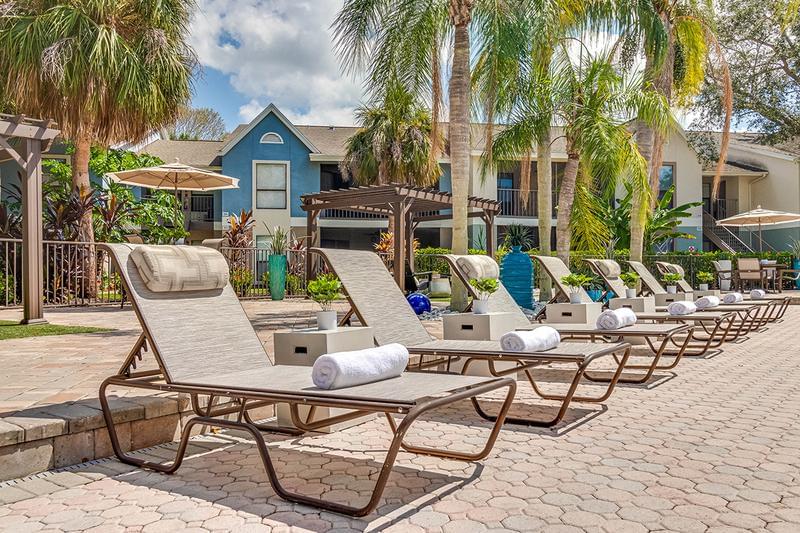 Lakeside Pool & Loungers | Relax by the pool in one of our loungers and enjoy beautiful Naples lake views.