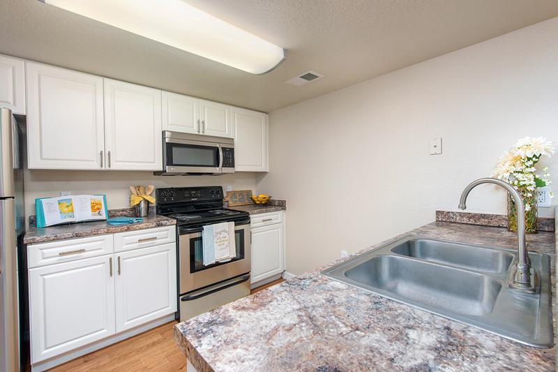 Kitchen | Large kitchens, fully equipped with stainless steel appliances and in-home laundry room.