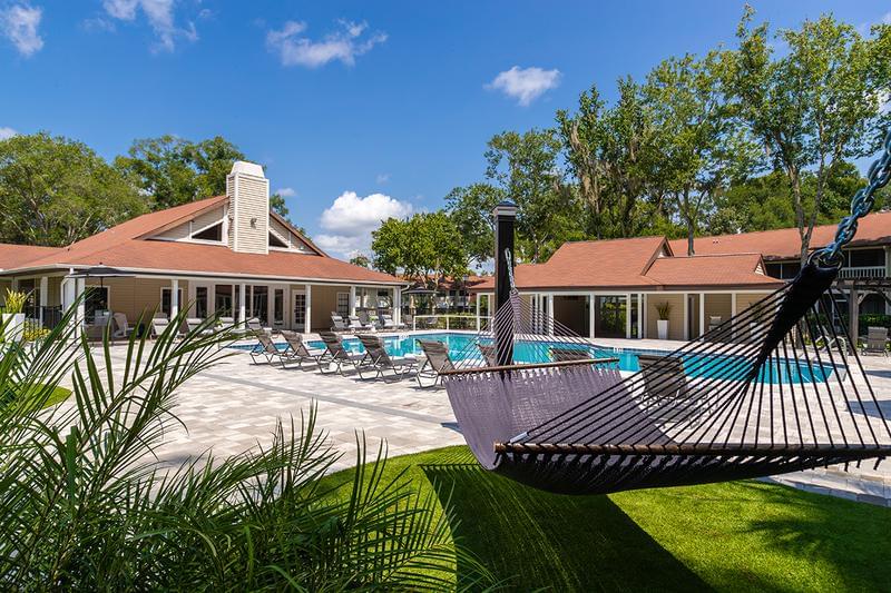 Spacious Pool Deck | Relax by the pool at our poolside hammock garden.
