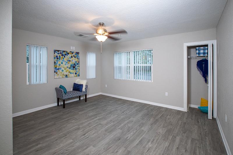 Spacious Living Room | Your spacious living room features either hardwood style flooring or plush carpeting, a ceiling fan, and a storage closet.