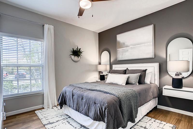Master Bedroom Suite | Spacious master suites featuring a walk-in closet, large window, and wood-style flooring.