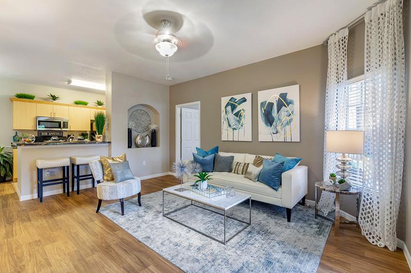 Largest Floor Plans in the Area | You'll love our open floor plan concepts including spacious living rooms with wood-style flooring and a ceiling fan.