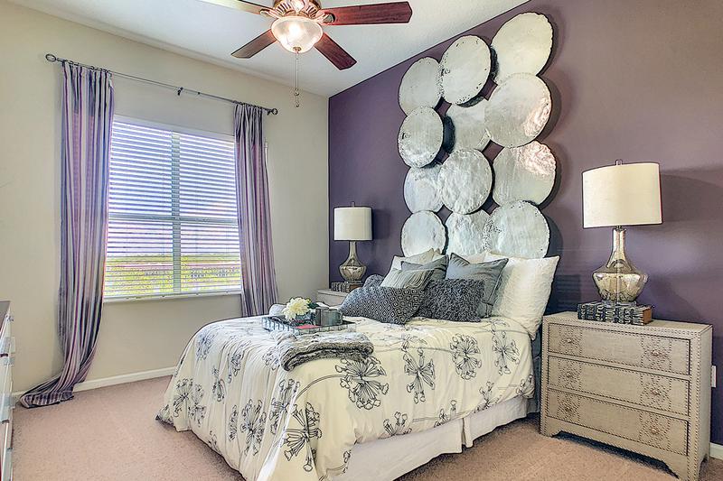 Bedroom | Spacious bedrooms with plush, neutral carpeting and ceiling fan.