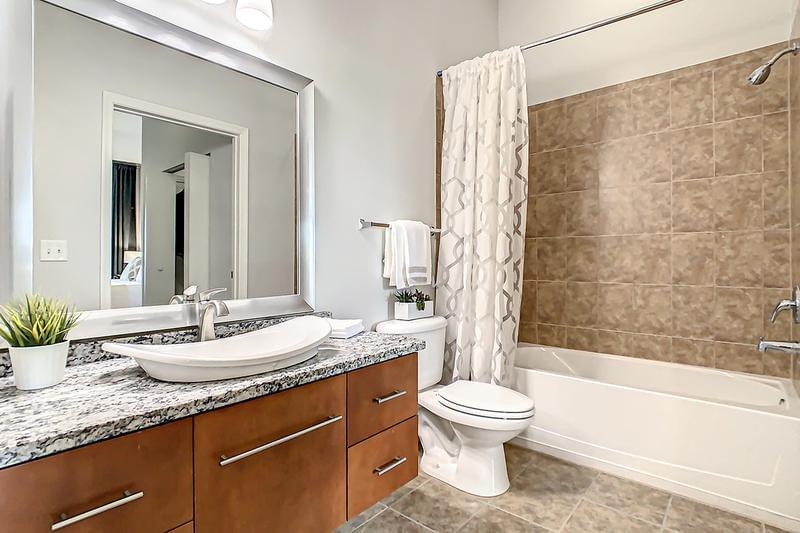 Guest Bathroom | Updated bathrooms featuring large mirrors.
